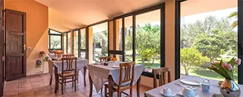 Breakfast veranda and relaxing view of the garden at Villa Grazia Bed & Breakfast in Alghero, Sardinia.